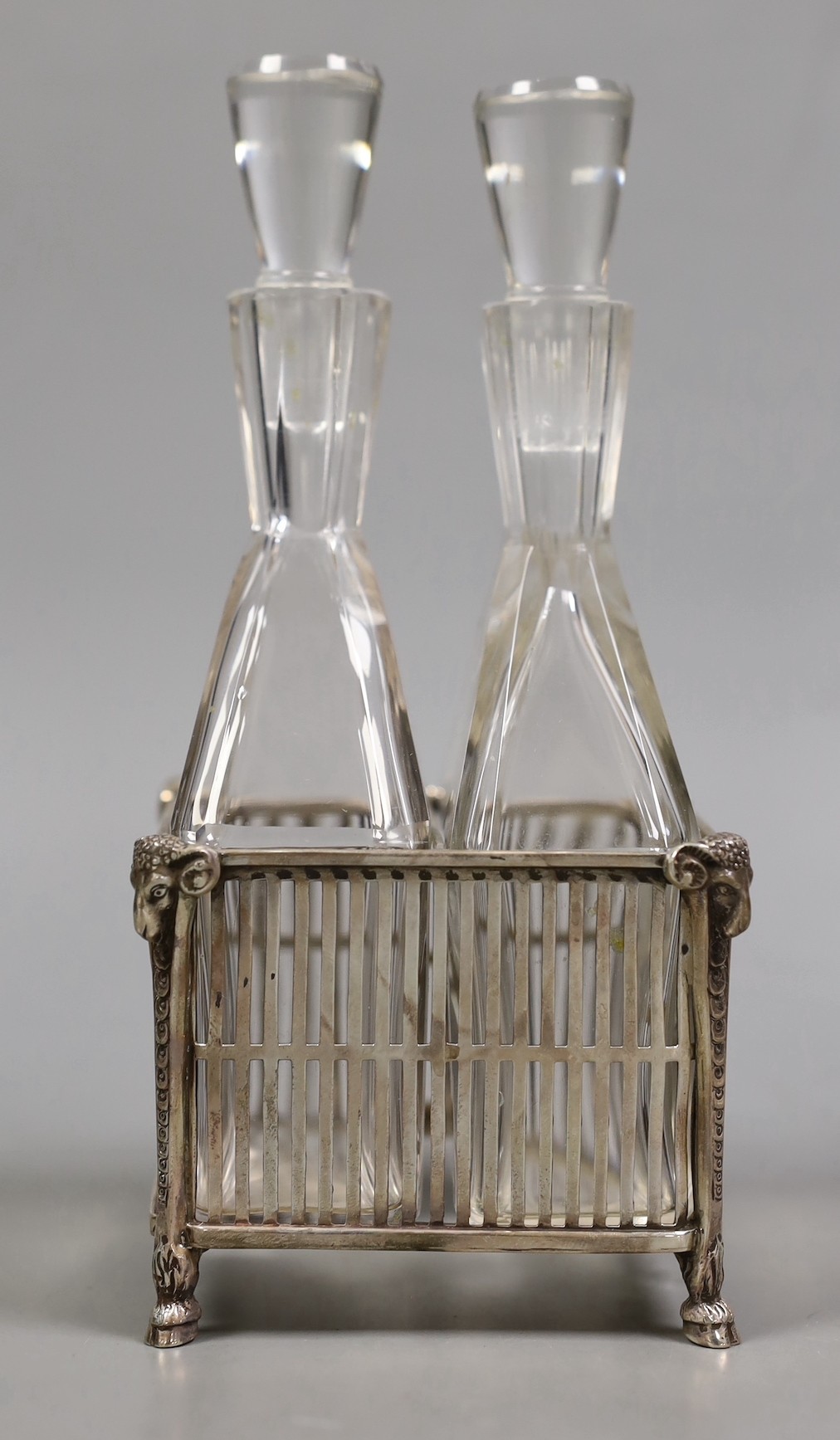 A boxed George V silver oil and vinegar stand, by Reid & Sons, London, 1911, with two Steuban glass bottles with stoppers, height 17.8cm.